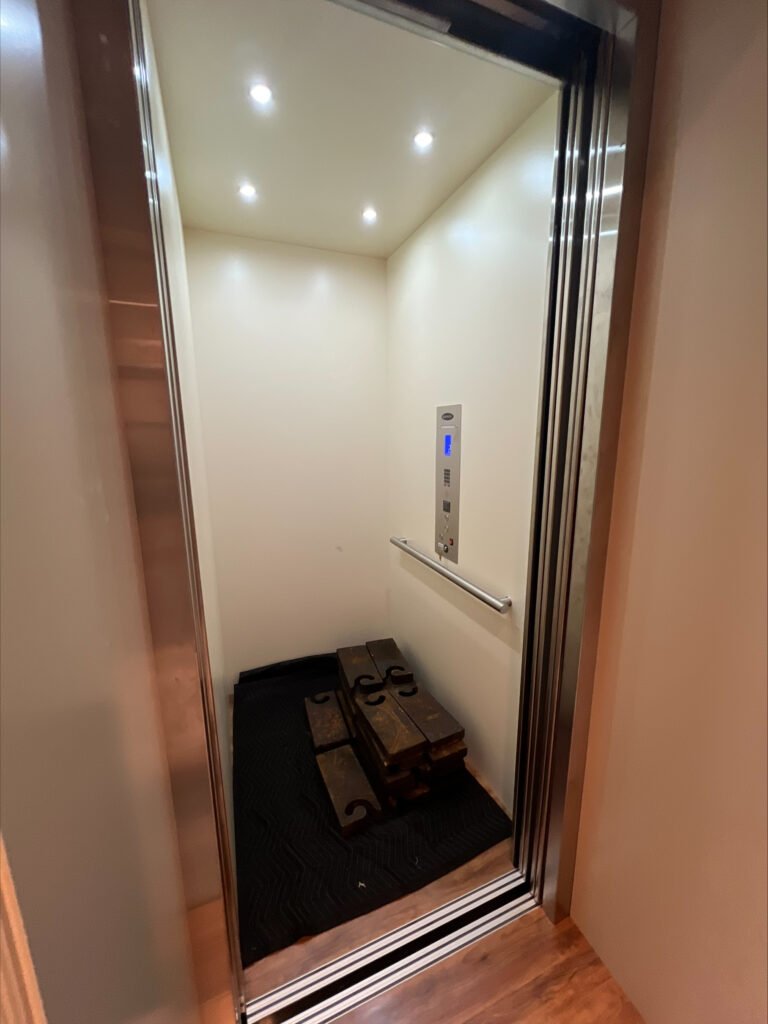 Luxury traction home elevator interior with powered sliding doors and LED lighting installed in North Texas DFW home
