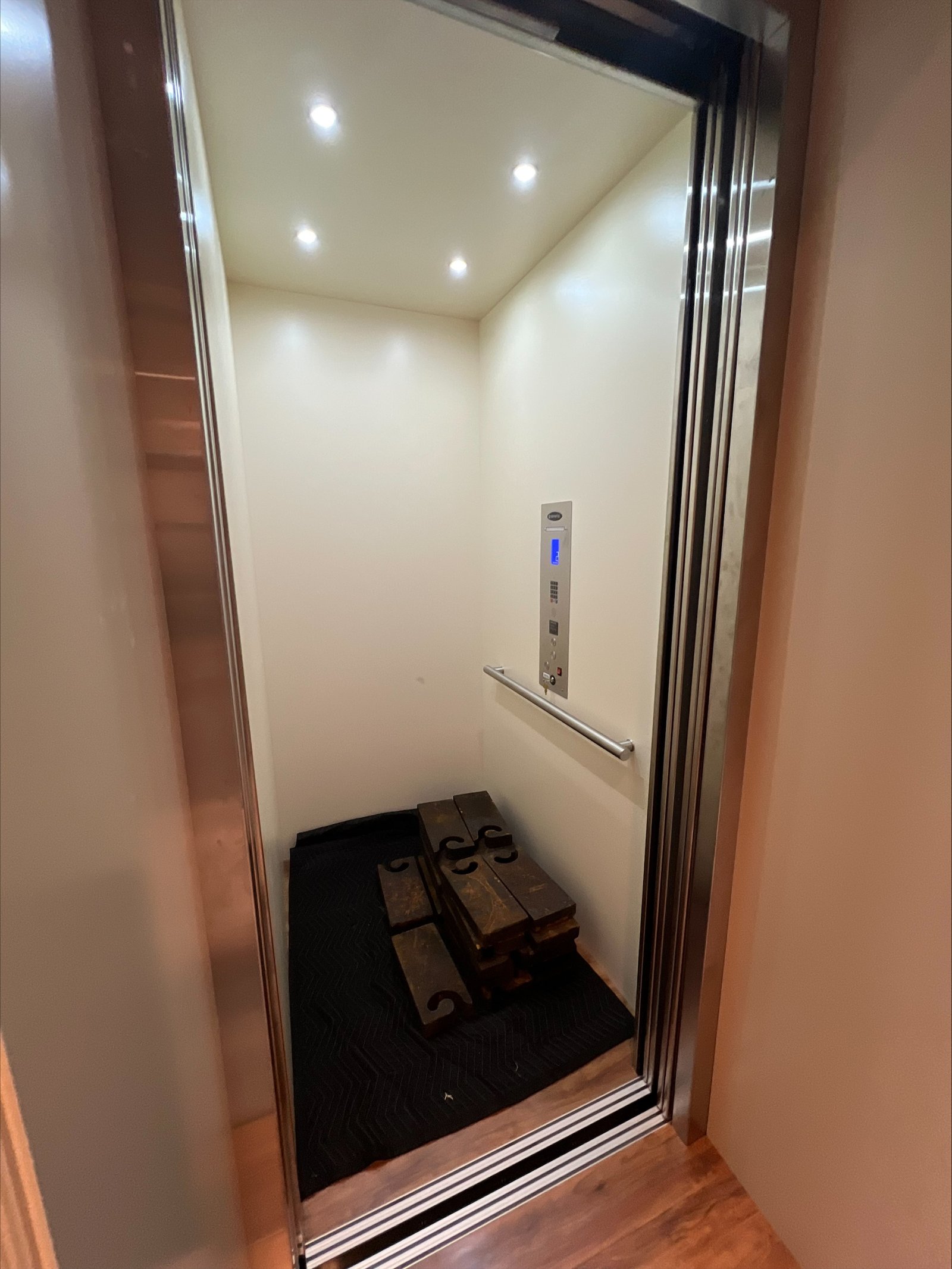 Luxury traction home elevator interior with powered sliding doors in North Texas